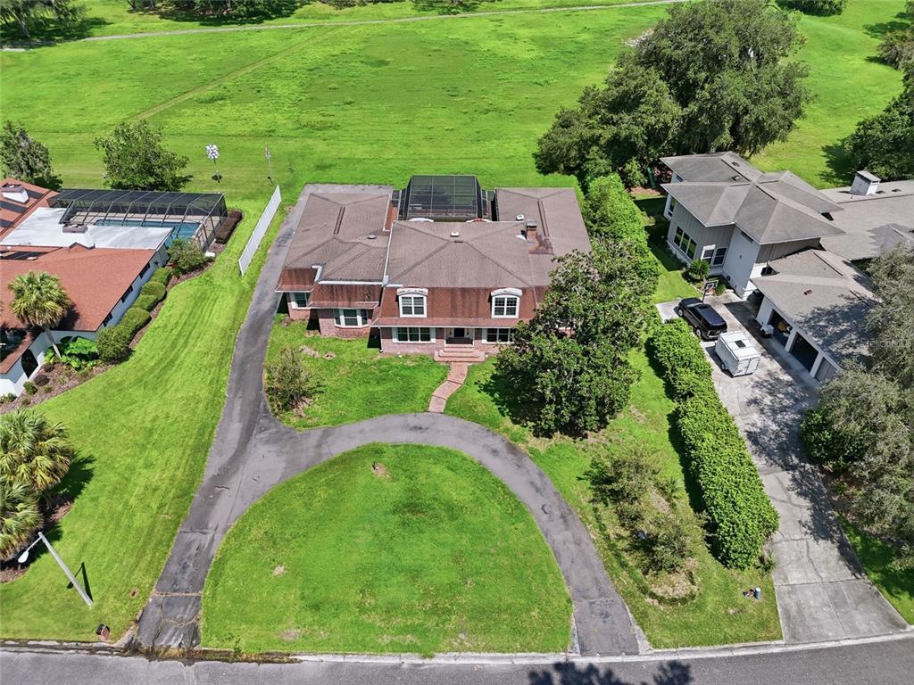An aerial view shows a two-story house with a circular driveway and a backyard pool — 6319 SW 37TH WAY, GAINESVILLE, FL