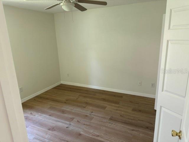 An empty bedroom features light-colored walls, wood-look flooring, and a ceiling fan — 20 UNION RUN COURT, PALM COAST, FL