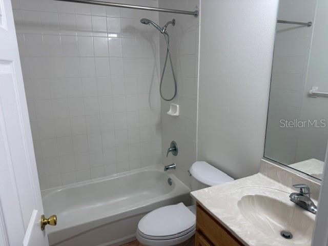 A bathroom featuring a white tiled shower-tub combination, a toilet, and a vanity with sink — 20 UNION RUN COURT, PALM COAST, FL