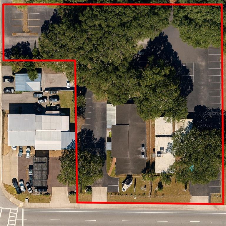 An aerial view shows two commercial buildings with parking lots and mature trees — 706 E BRANDON BOULEVARD, BRANDON, FL