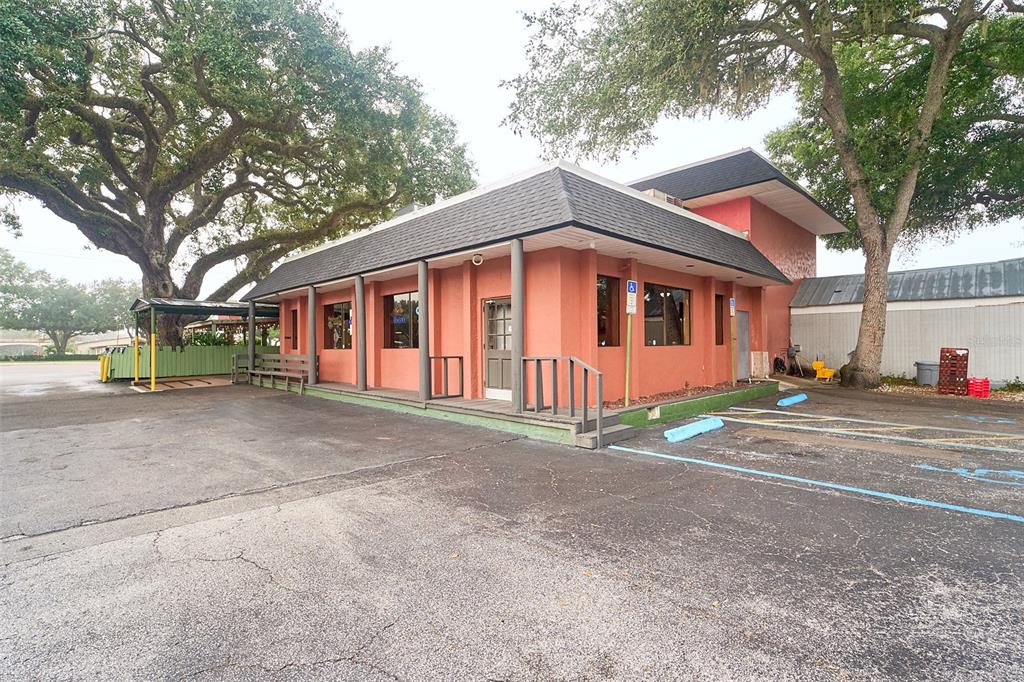 A single-story commercial building with a terracotta exterior and a dark shingled roof — 706 E BRANDON BOULEVARD, BRANDON, FL