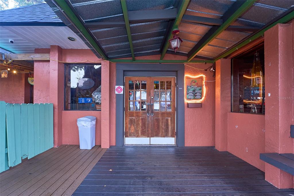 The exterior entrance of a building features a wooden deck, double doors, and a canopy — 706 E BRANDON BOULEVARD, BRANDON, FL