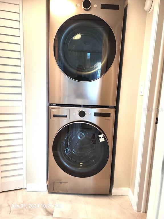 A stacked LG washer and dryer unit sits in a laundry closet with white flooring — 3940 INVERRARY BOULEVARD UNIT 703A, LAUDERHILL, FL