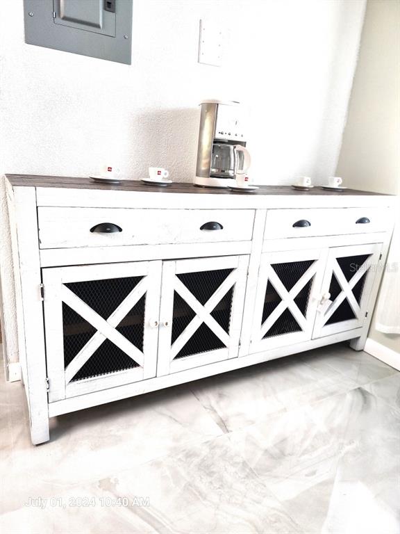 A white wooden sideboard with wire mesh cabinet doors sits against a wall — 3940 INVERRARY BOULEVARD UNIT 703A, LAUDERHILL, FL