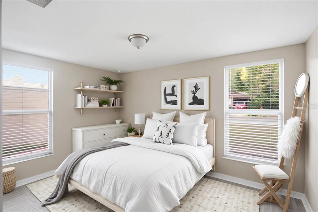 A bedroom features a white bed, floating shelves, a dresser, and two windows with blinds — 1514 CREST AVENUE, LEESBURG, FL
