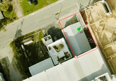 An aerial view shows a rectangular property lot outlined in red with a small building — 115-119 MICHIGAN AVENUE, DAYTONA BEACH, FL