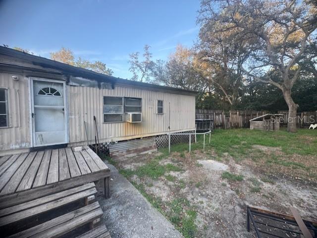 An exterior view of a mobile home with a wooden deck and a fenced backyard — 4639 CR 690, WEBSTER, FL