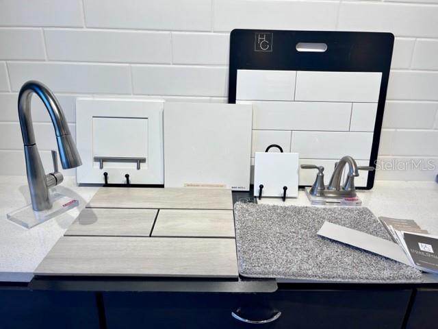A display of interior design finish samples including tile, cabinetry, flooring, and plumbing fixtures — 1261 DAISY HILL AVENUE, DUNDEE, FL