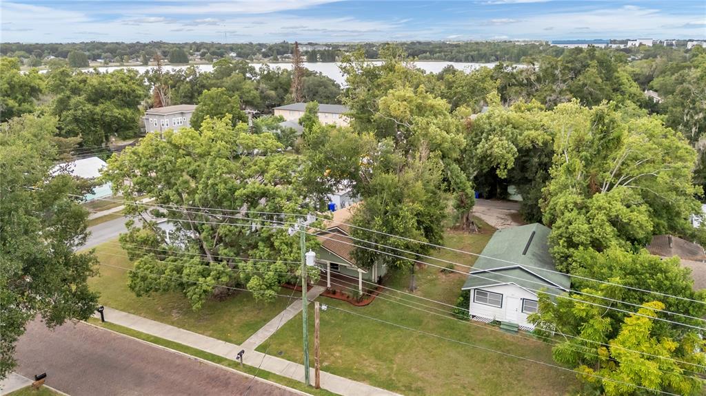 A covered wooden porch with green siding, a dark front door, and large white-framed windows — 541 W PARK STREET, LAKELAND, FL