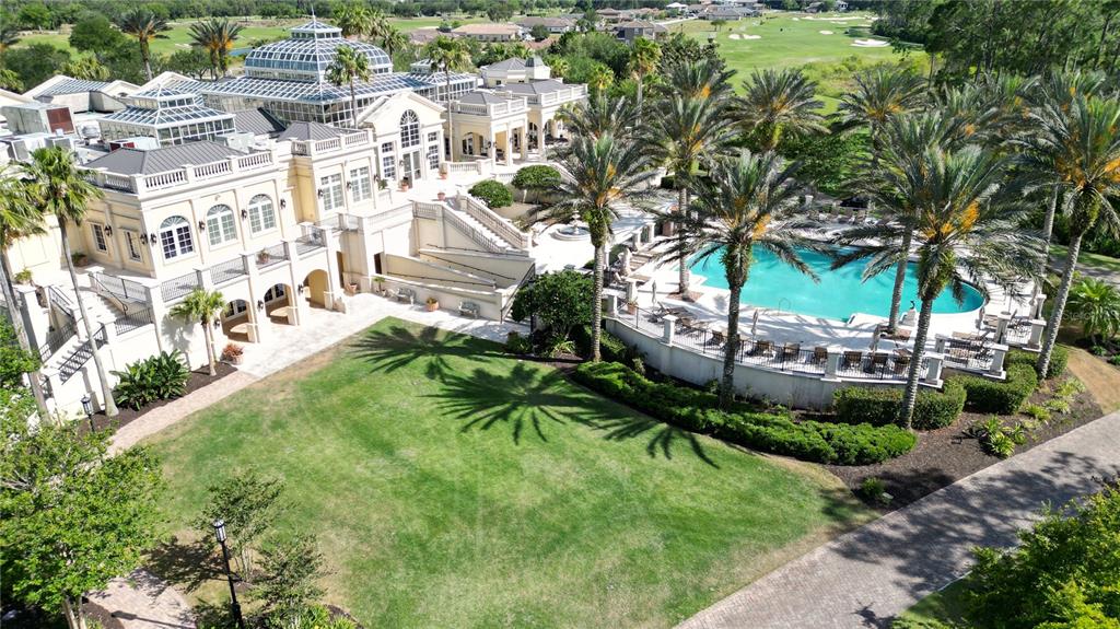 An aerial view of a large estate featuring a swimming pool, lawn, and glass conservatory — 105 HICKORY COURT, PALM COAST, FL