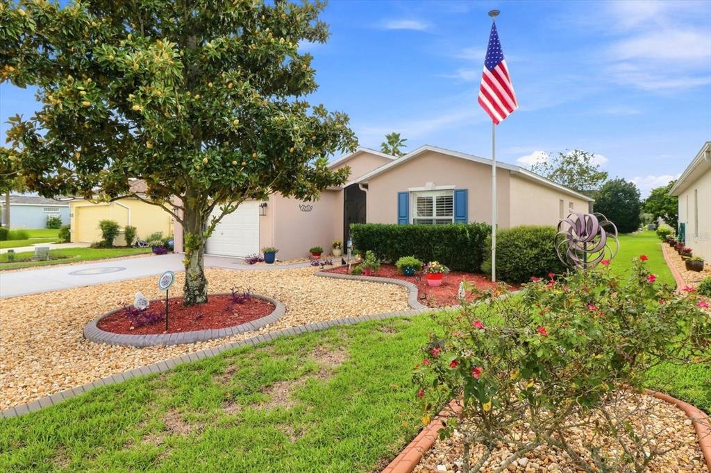A single-story house with a large tree, a flagpole, and a landscaped front yard — 16367 SW 13TH TERRACE, OCALA, FL