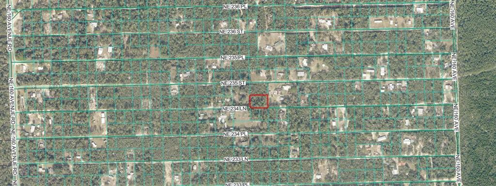 This is an aerial map showing a highlighted rectangular property lot within a residential grid — TBD NE 234TH LANE, FORT MC COY, FL