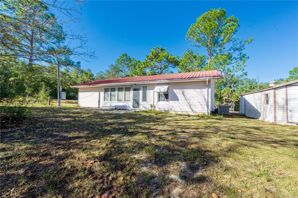 An aerial view shows a house on a triangular lot surrounded by trees and roads — 11216 NE 63RD PLACE, WILLISTON, FL