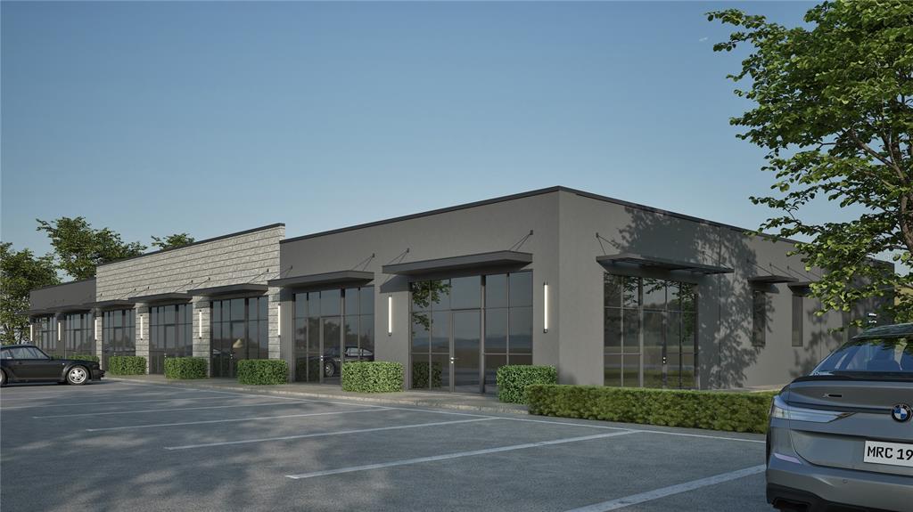 A rendering of a modern, single-story commercial building with gray stucco and glass storefronts — 0 PROGRESS LANE UNIT 1, ST CLOUD, FL