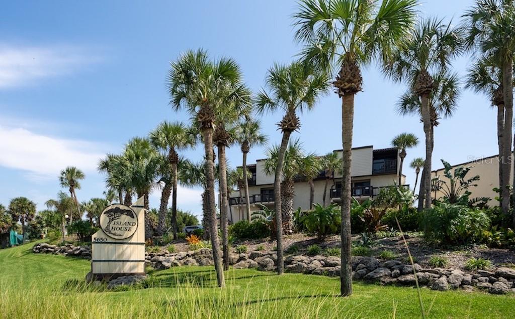 A sign for Island House stands in front of palm trees and a multi-story building — 5650 S A1A UNIT UNIT G117, ST AUGUSTINE, FL
