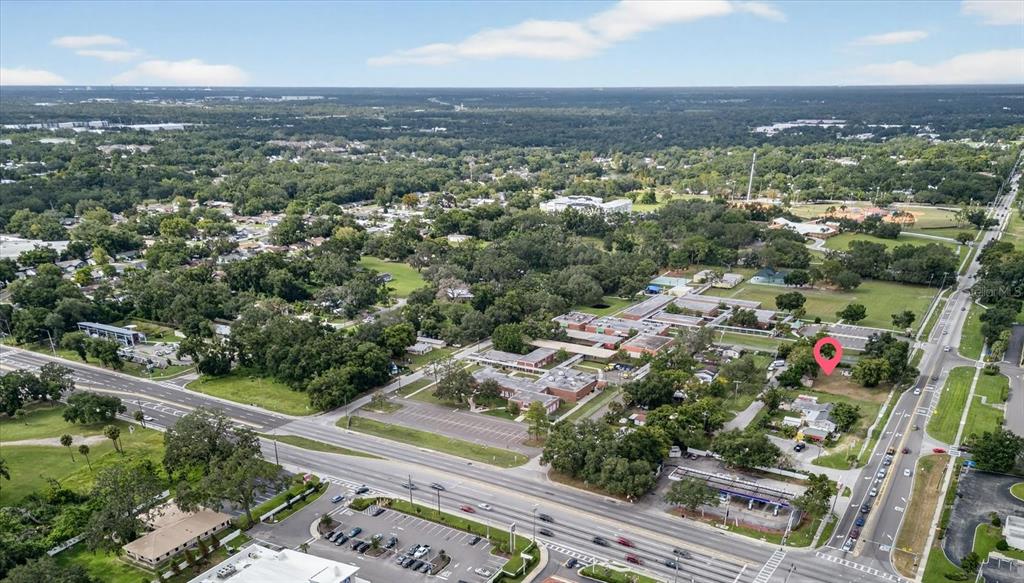 An aerial view shows a commercial property with a red pin marking a specific lot — 4020 579 HIGHWAY, SEFFNER, FL