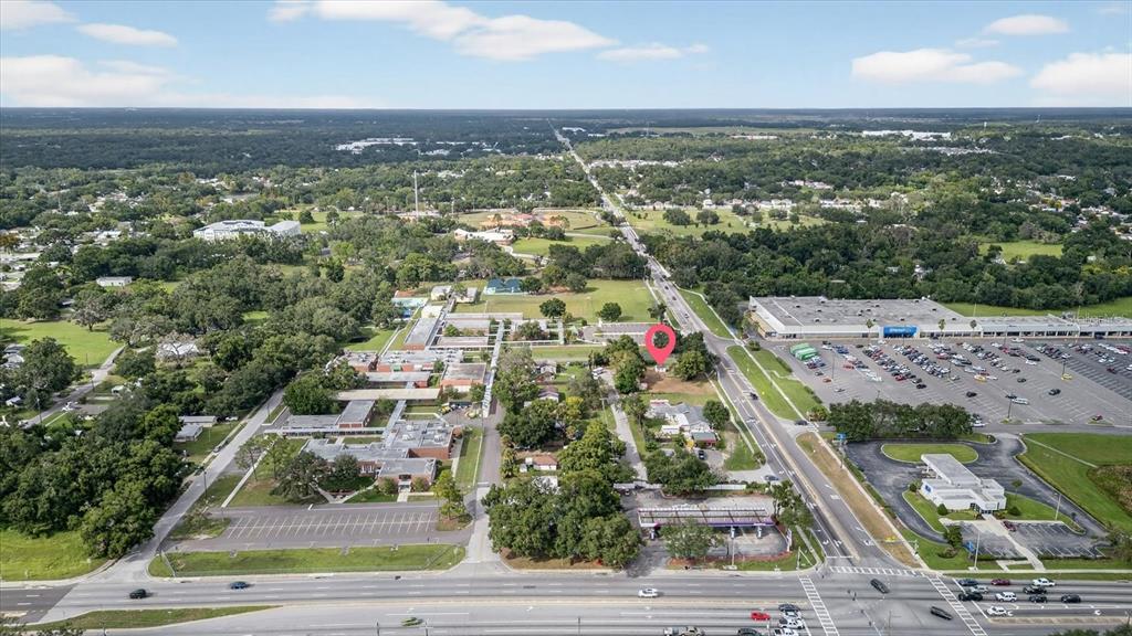An aerial view shows a commercial area with a school, a shopping center, and roads — 4020 579 HIGHWAY, SEFFNER, FL
