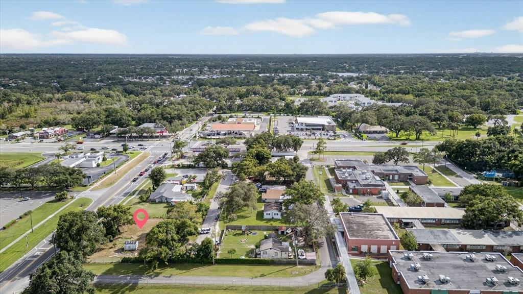 An aerial view shows a vacant lot marked with a pin near a school building — 4020 579 HIGHWAY, SEFFNER, FL