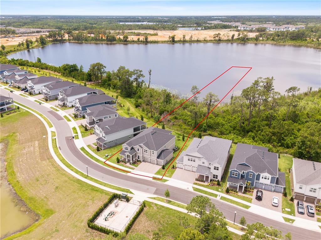 A two-story gray house with a three-car garage and a covered front entryway — 17372 GLOSSY POMELO WAY, WINTER GARDEN, FL