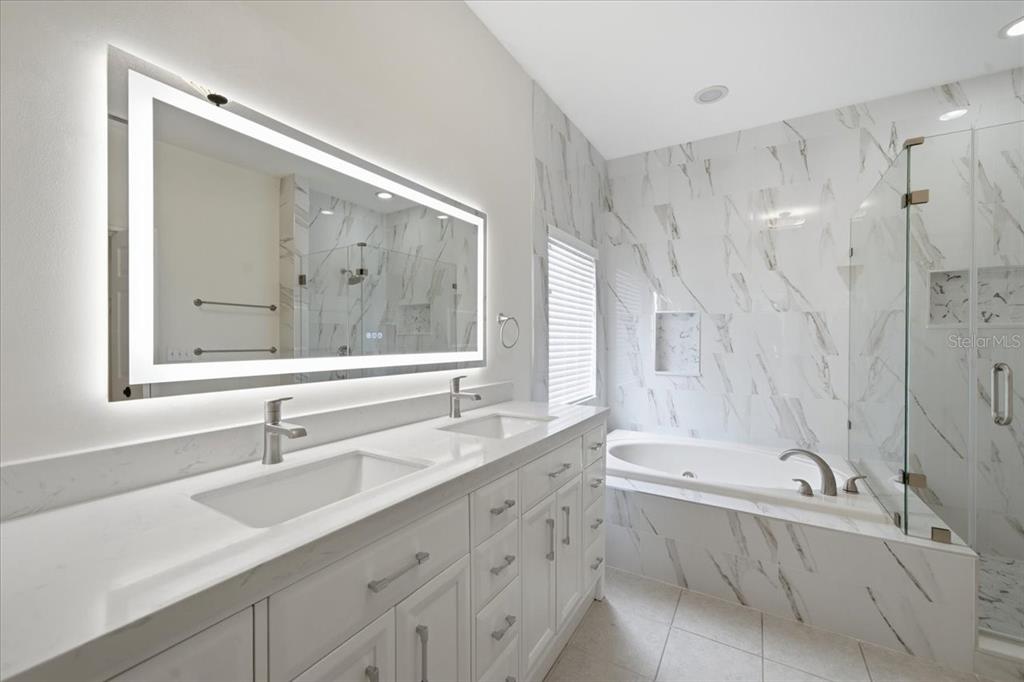 An empty room with hardwood floors, a chandelier, and a half-wall divider — 1333 LINDENWOOD DRIVE, TARPON SPRINGS, FL