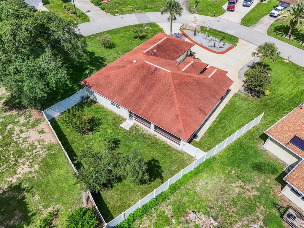 An aerial view shows a single-story house with a red roof and a fenced backyard — 43 FOLSON LANE, PALM COAST, FL