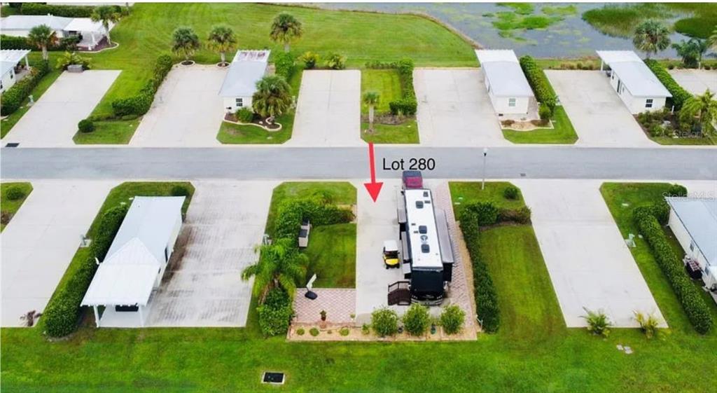 An aerial view shows a paved lot with an RV and a golf cart — 9531 SE 47TH WAY UNIT 280, WEBSTER, FL