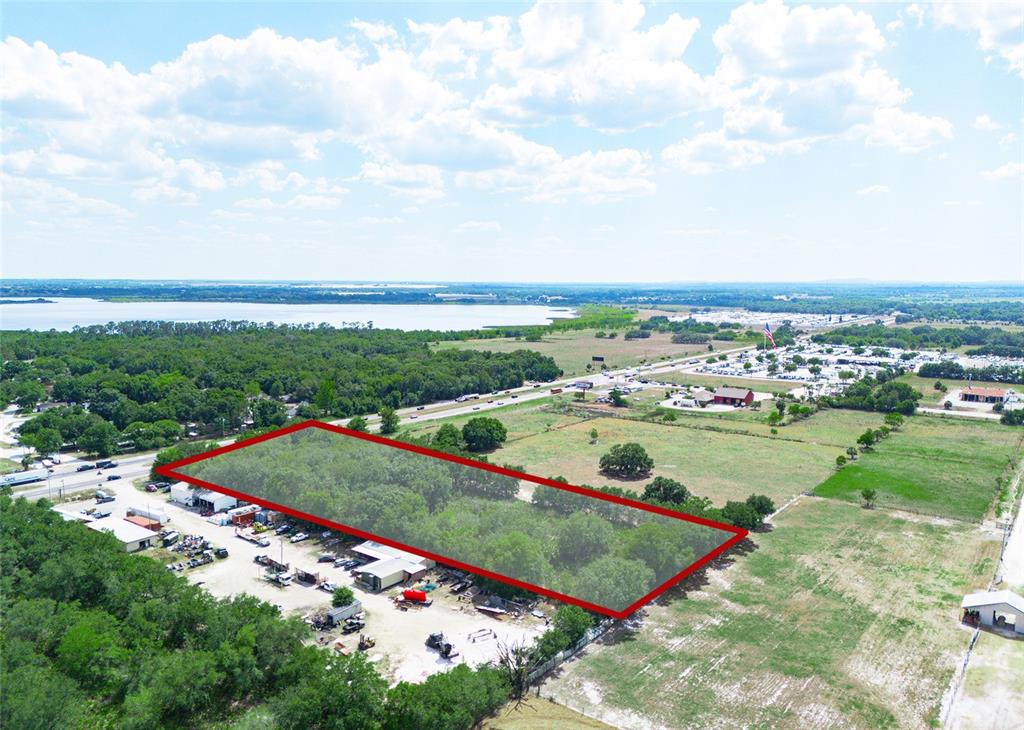 An aerial view shows a rectangular plot of land outlined in red near a highway — SR-60, BARTOW, FL