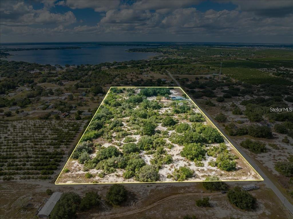 An aerial view shows a large, rectangular plot of land with trees and a house — LIBBY RD, BABSON PARK, FL