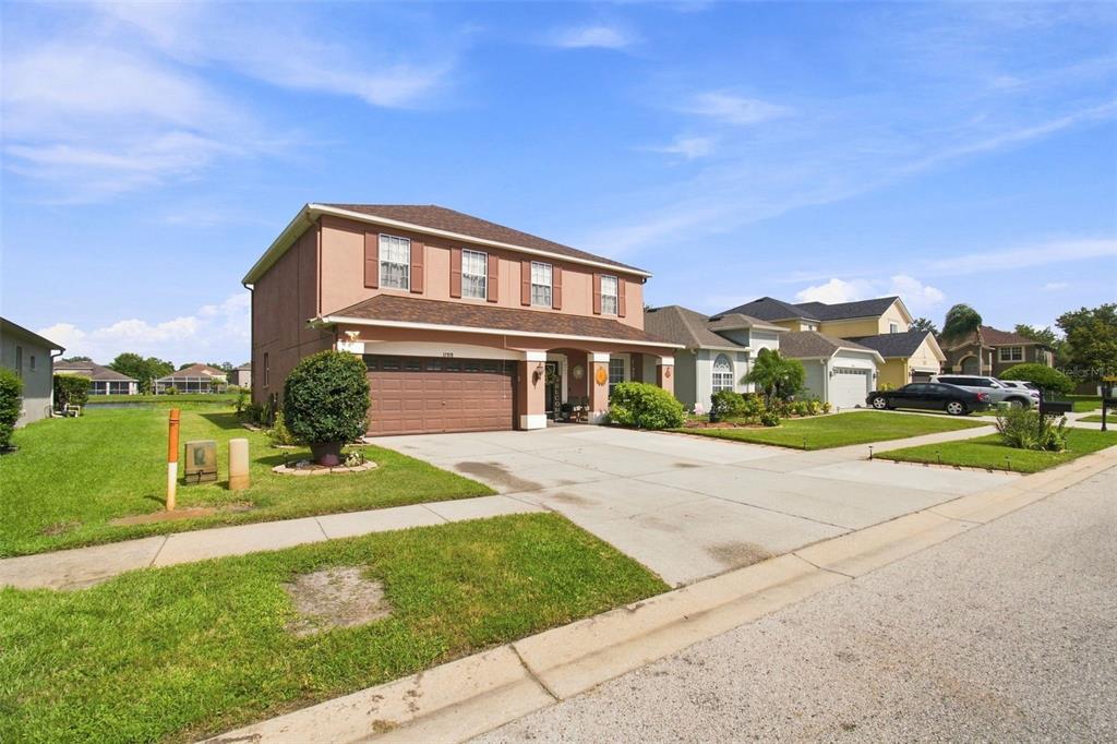 A two-story suburban house with a brown garage and a concrete driveway — 17919 AYRSHIRE BOULEVARD, LAND O LAKES, FL