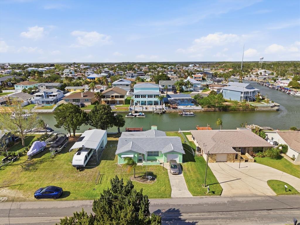 An aerial view shows a waterfront house with a boat dock and a camper — 4069 GULFVIEW DRIVE, HERNANDO BEACH, FL