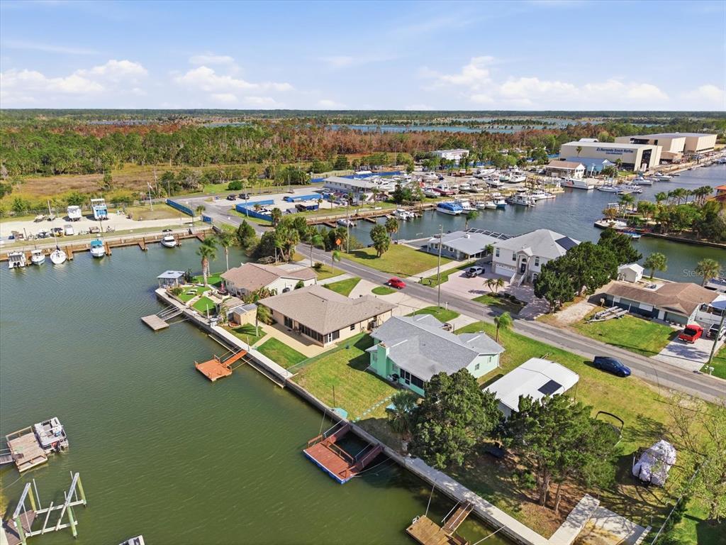 An aerial view shows waterfront houses with private docks along a canal near a marina — 4069 GULFVIEW DRIVE, HERNANDO BEACH, FL