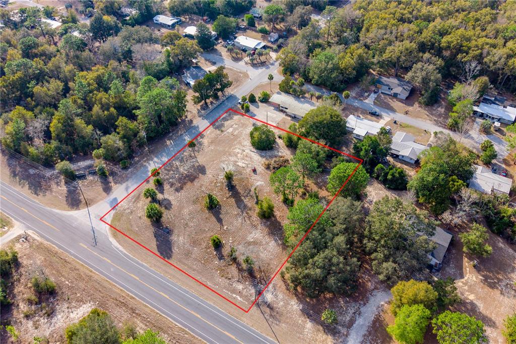 An aerial view shows a vacant, rectangular plot of land outlined in red near roads — TBD NE STATE RD 121, LOT 2, WILLISTON, FL
