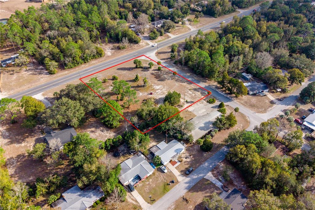 An aerial view shows a vacant, rectangular lot outlined in red bordered by two roads — TBD NE STATE RD 121, LOT 2, WILLISTON, FL