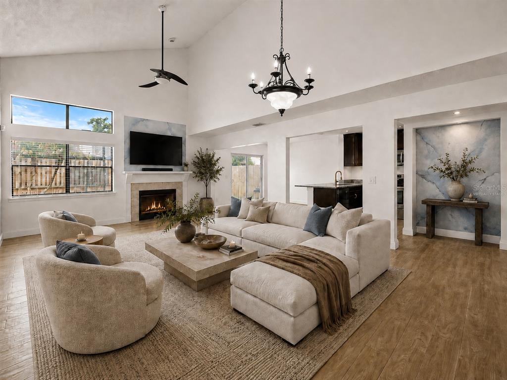 A two-story house with tan siding, brick accents, a two-car garage, and an orange front door — 3109 BRIDGEFORD DRIVE, ORLANDO, FL
