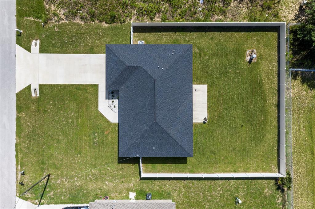 An aerial view shows a house with a dark roof, a driveway, and a fenced yard — 18 DOGWOOD TRAIL COURSE, OCALA, FL
