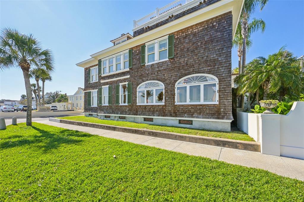A two-story house with wood shingle siding, green shutters, and a white rooftop railing — 178 AVENIDA MENENDEZ, ST AUGUSTINE, FL