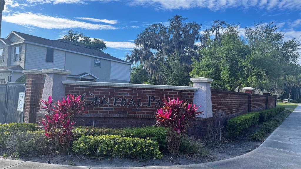 A brick wall with a Central Park sign stands in front of a residential building — 103 MAYO COURT, OVIEDO, FL