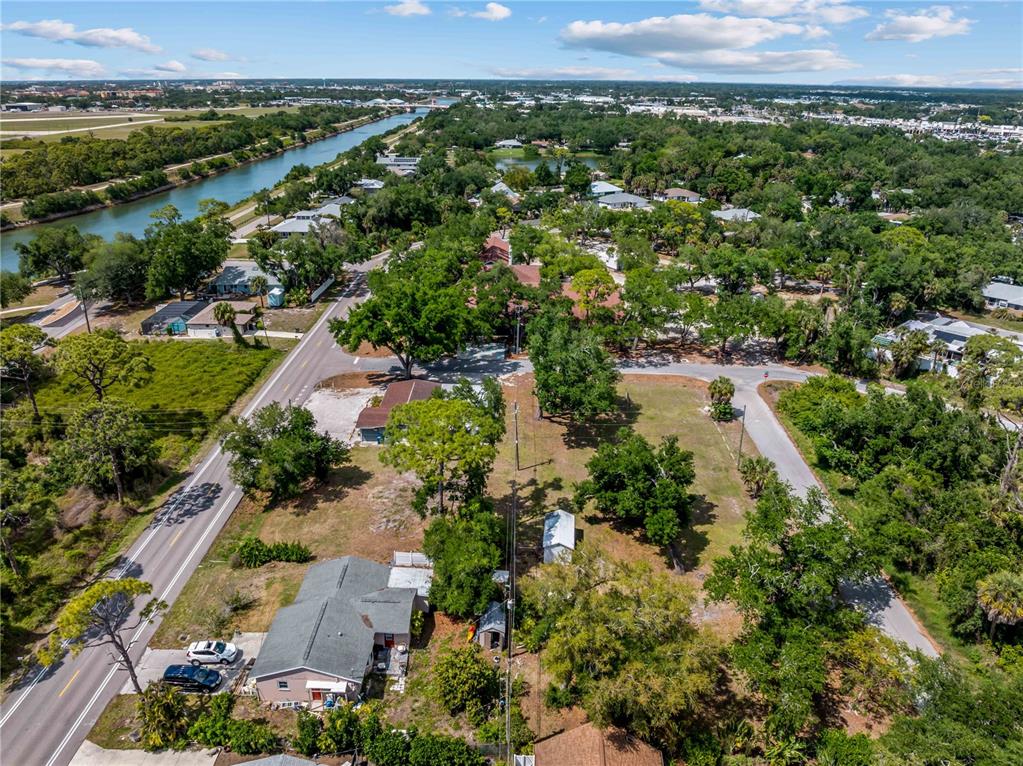 An aerial view shows a residential property with a house, outbuildings, and surrounding trees — DAWN DRIVE, VENICE, FL