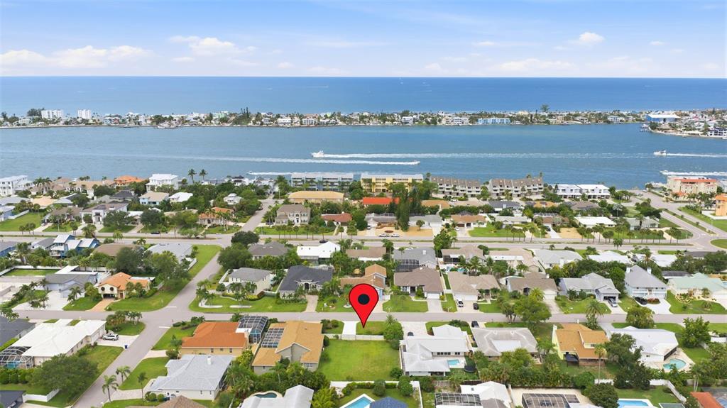 An aerial view shows a vacant residential lot marked with a pin in a coastal neighborhood — 343 7TH AVENUE N, TIERRA VERDE, FL