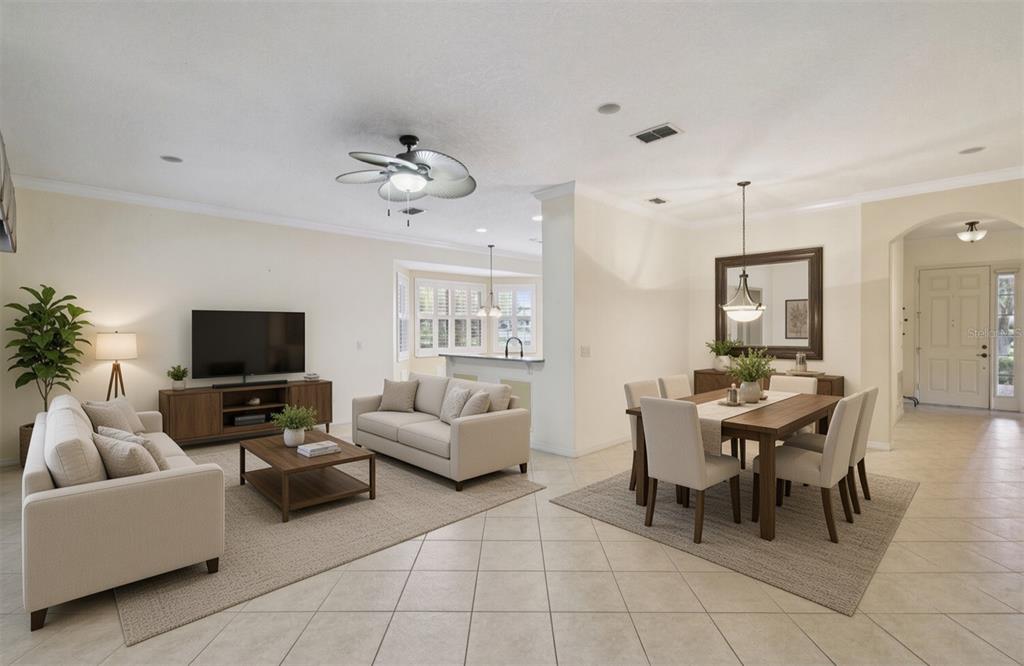A dining area with tile flooring, a hanging light fixture, and a large framed mirror — 100 FLAME VINE WAY, GROVELAND, FL