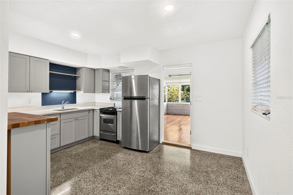 A kitchen with gray cabinets, stainless steel appliances, and a dark blue backsplash — 4501 26TH AVENUE S, ST PETERSBURG, FL