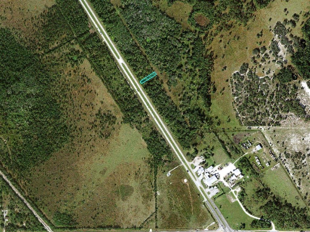 An aerial view shows a rectangular plot of land highlighted in teal along a road — US 27 HIGHWAY, FROSTPROOF, FL