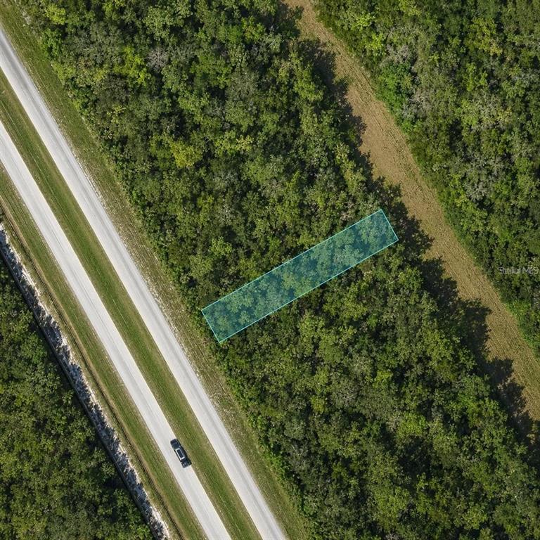 An aerial view shows a rectangular highlighted plot of land adjacent to a paved road — US 27 HIGHWAY, FROSTPROOF, FL