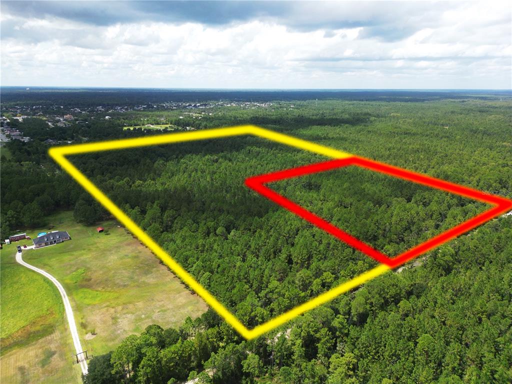 An aerial view shows a large, wooded plot of land outlined in yellow and red — 2220 OLD TRAIN ROAD, DELTONA, FL