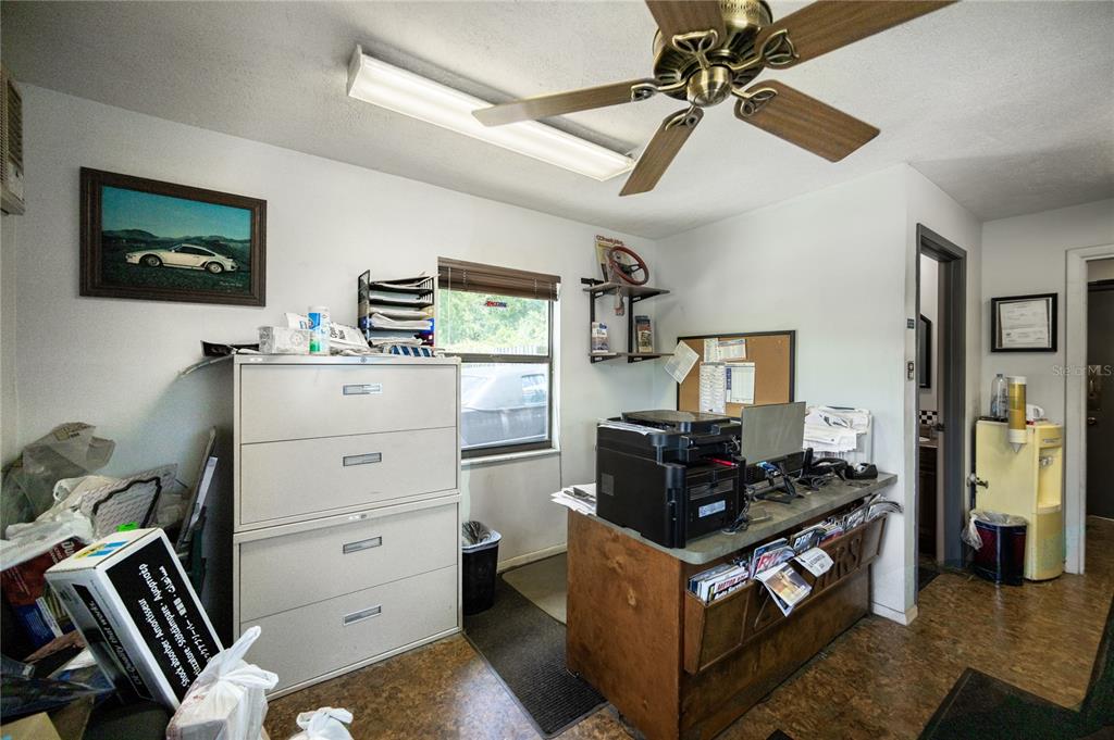 An office space features a desk, a filing cabinet, a ceiling fan, and a window — 3700 N US HIGHWAY 441, OCALA, FL