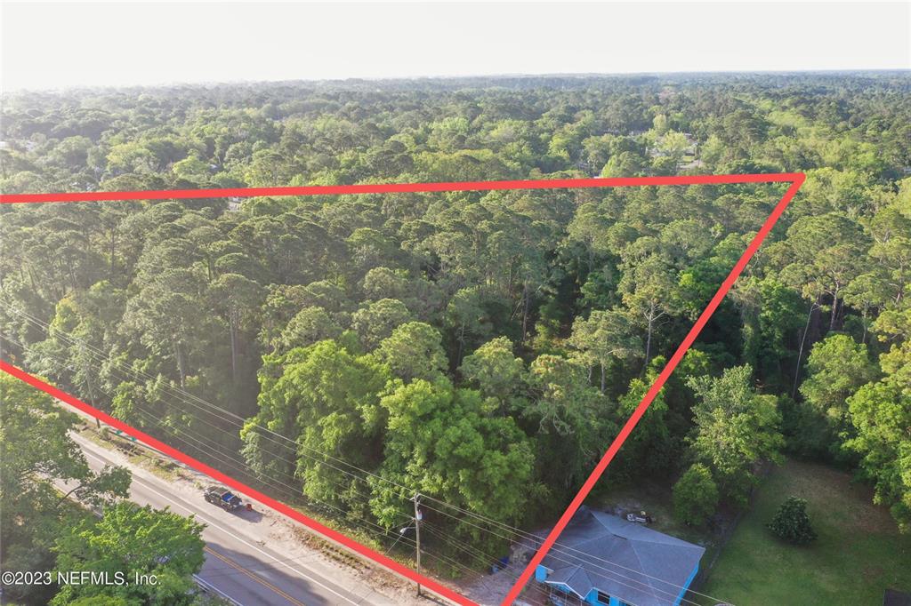An aerial view shows a wooded lot outlined in red next to a paved road — 901 W KING STREET, ST AUGUSTINE, FL
