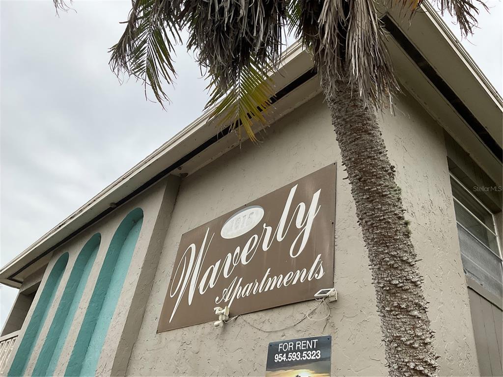 A low-angle view shows the exterior of the Waverly Apartments building with a palm tree — 1011 LAKEVIEW DRIVE, SEBRING, FL