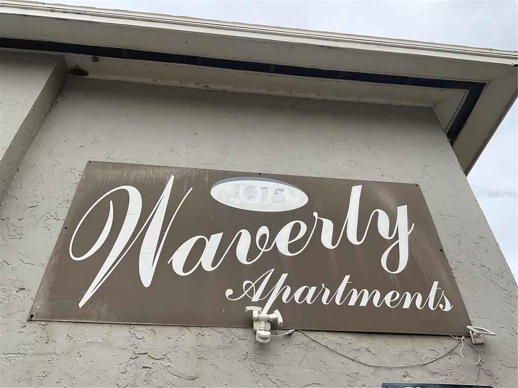 A brown sign for Waverly Apartments is mounted on a beige exterior wall — 1011 LAKEVIEW DRIVE, SEBRING, FL