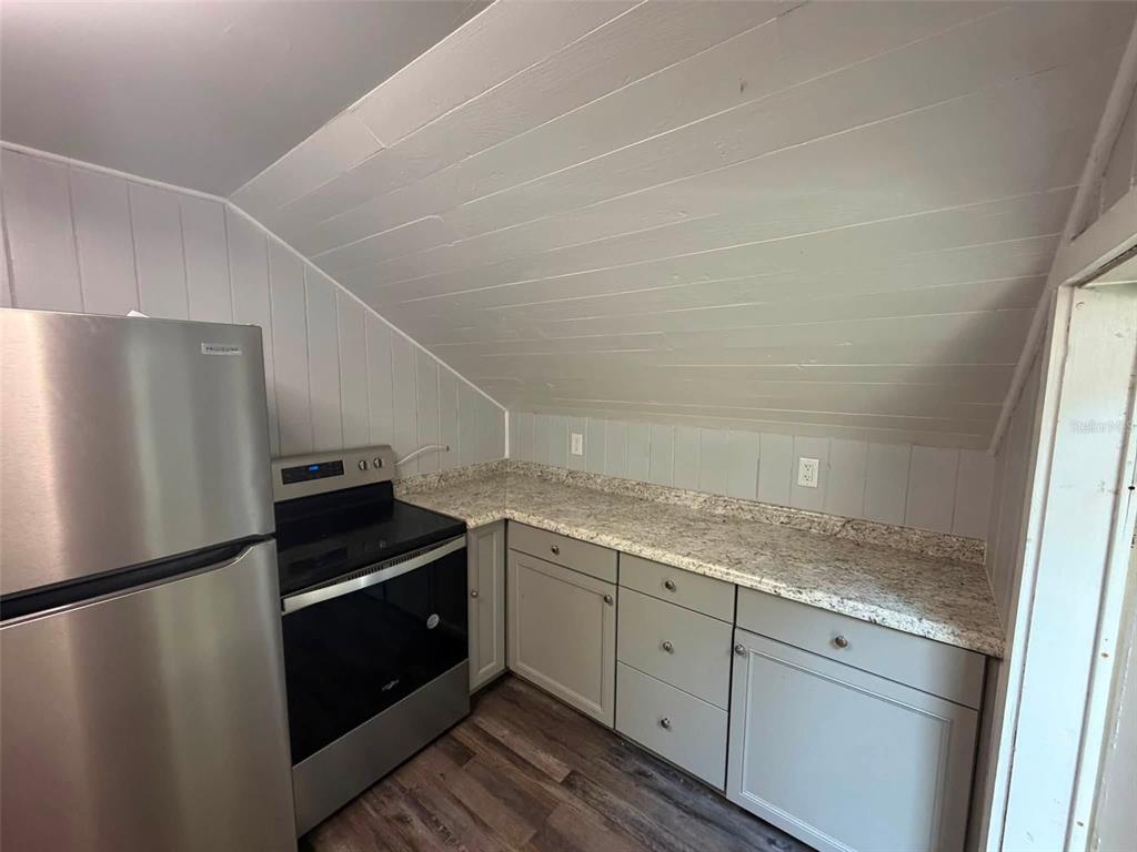 A room with wood-paneled ceiling, gray walls, wood-look flooring, and a window air conditioner — 41014 FLETCHER ROAD, UMATILLA, FL