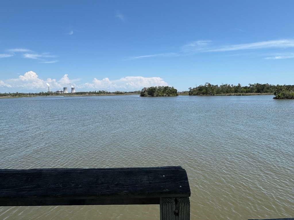 A view of a calm body of water with distant islands and a power plant — 11624 N LANDOVER TERRACE, DUNNELLON, FL